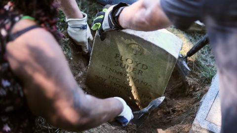 Volunteers excavate a World War I veteran's headstone that had sunk 2 feet into the earth at Lebanon Cemetery.