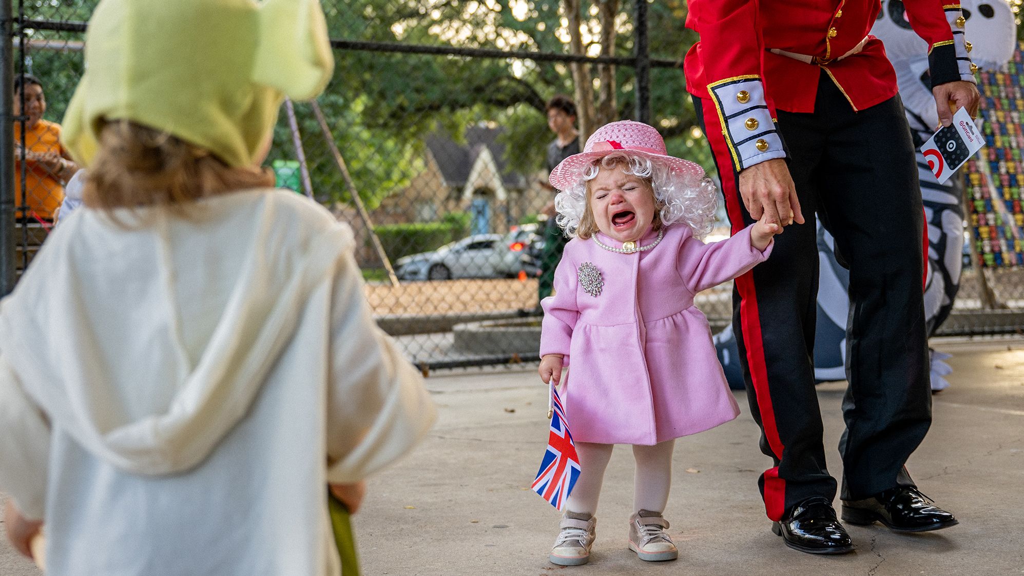 Madeline Evans begins to cry after winning a costume contest dressed as the late Queen Elizabeth II on Monday, October 31, in Houston, Texas.