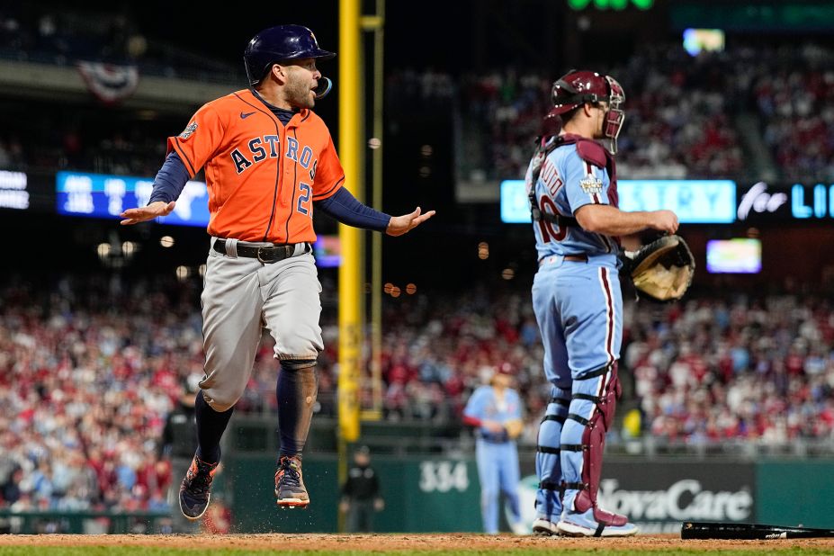 Houston's Jose Altuve celebrates after scoring on a ball hit by Yordan Alvarez.