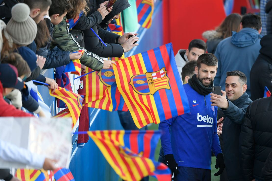 Piqué poses for a fan during a public training session at the Joan Gamper Sports City training ground in Sant Joan Despi on January 5, 2020.