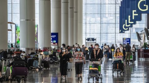 Travelers in the departure hall at Hong Kong International Airport following the government's scrapping of hotel quarantine, on September 26.