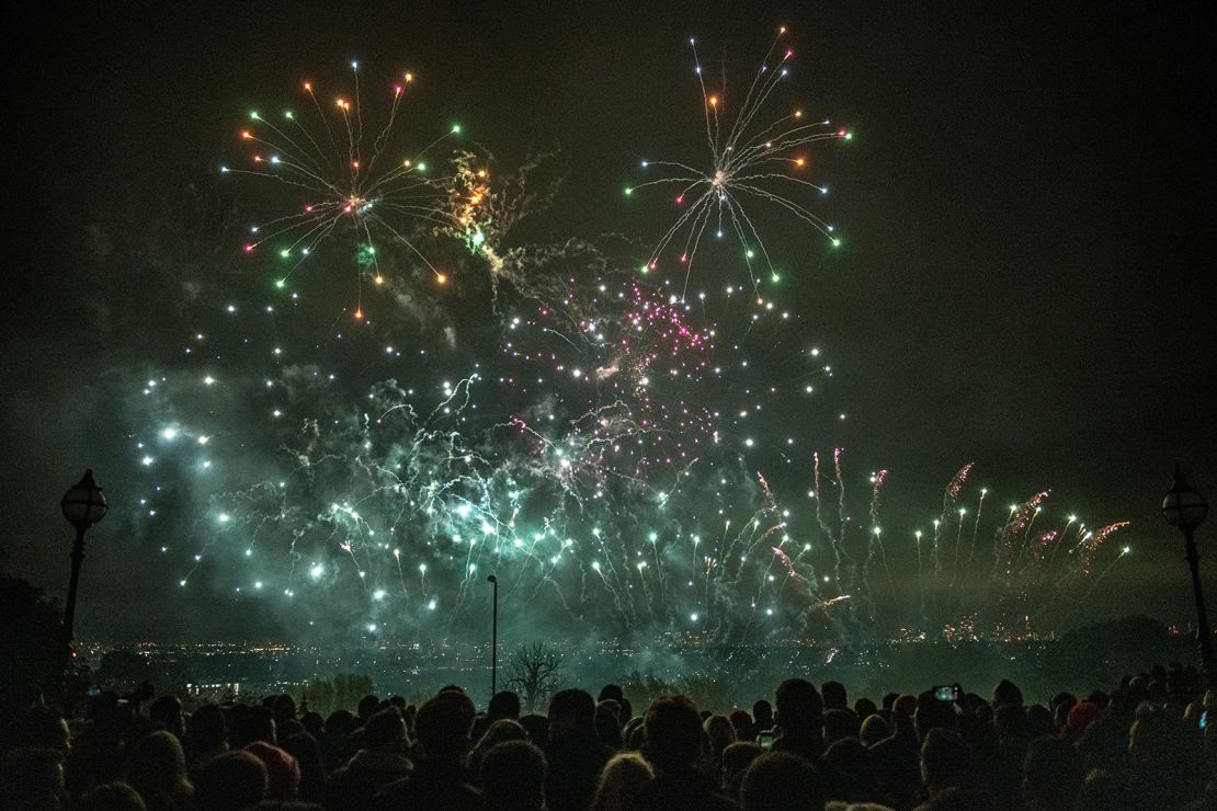 Crowds watching a firework display as part of Guy Fawkes Night celebrations at Alexandra Palace in London in 2021.