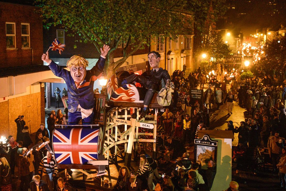 Effigies of former UK prime minister Boris Johnson and fellow UK Conservative politician Jacob Rees-Mogg are paraded through the streets of Lewes during traditional Bonfire Night celebrations in 2019.