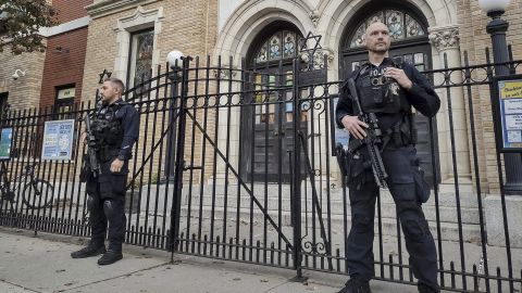 Police officers stand watch outside the United Synagogue of Hoboken, New Jersey, on Thursday. 
