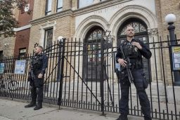 Police officers stand watch outside the United Synagogue of Hoboken, New Jersey, on Thursday. 