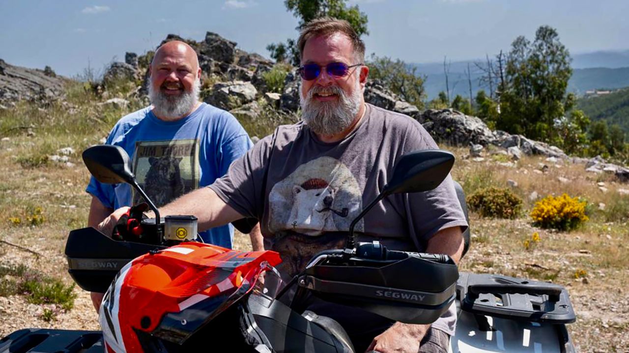 Bill Mauro, right, and Marcus Laurence ride ATVs near their home in the mountains near Coimbra. 