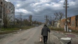 An old woman walks in the Kherson region village of Arkhanhelske on November 3, 2022, which was formerly occupied by Russian forces. (Photo by BULENT KILIC / AFP) (Photo by BULENT KILIC/AFP via Getty Images)