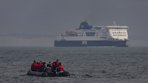 An inflatable craft carrying migrants crosses the shipping lane in the English Channel towards the white cliffs at Dover on August 4, 2022 off the coast of Dover, England. 