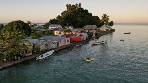 The morning's first rays of sunlight hit the island community of Serua Village, Fiji, in July.