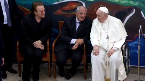 Bono, far left, meets with Pope Francis and other leaders at an event on May 19, 2022, in Vatican City.