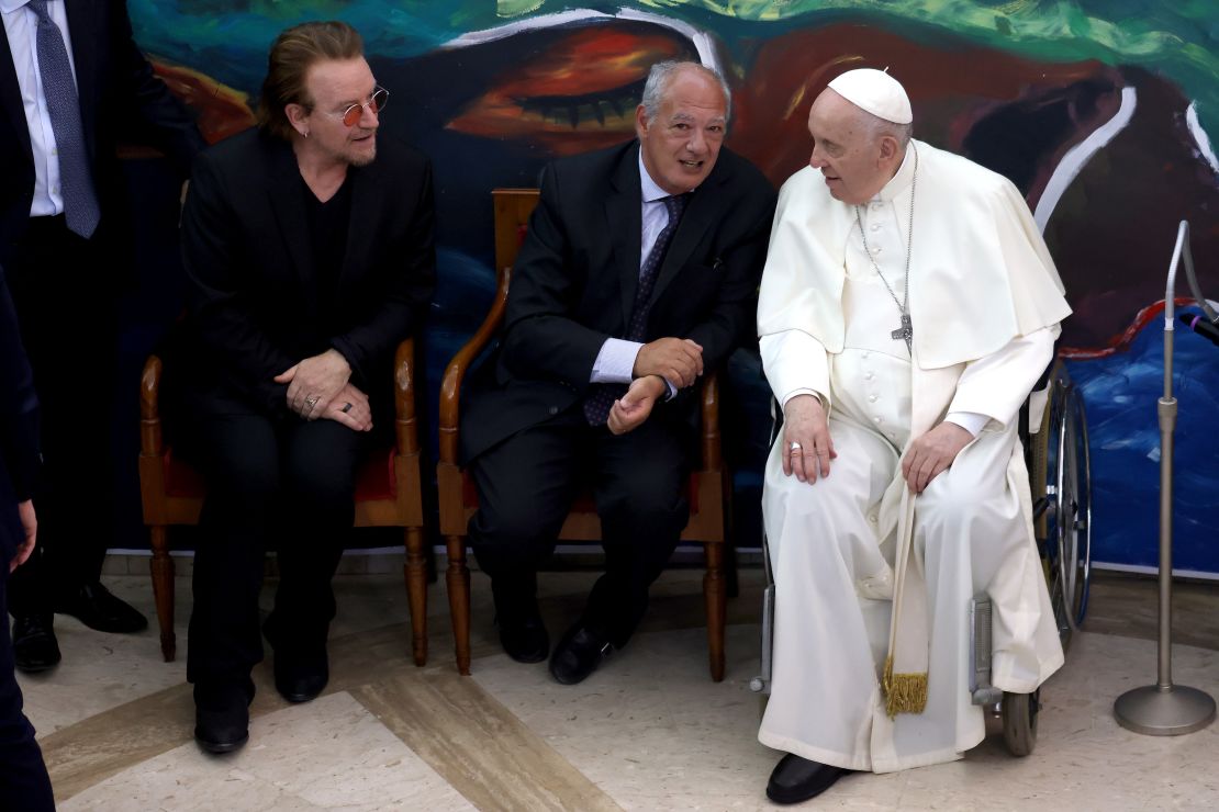 Bono, far left, meets with Pope Francis and other leaders at an event on May 19, 2022, in Vatican City. 