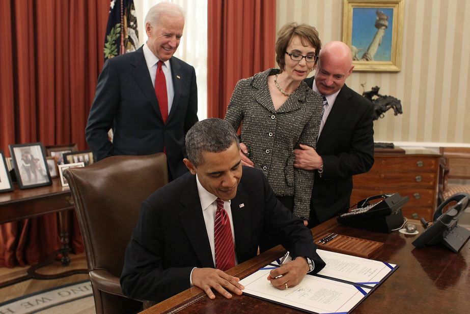 Giffords, Kelly and then-Vice President Joe Biden watch Obama sign the Ultralight Aircraft Smuggling Prevention Act in February 2012. The bill was the last piece of legislation Giffords voted on before she resigned.