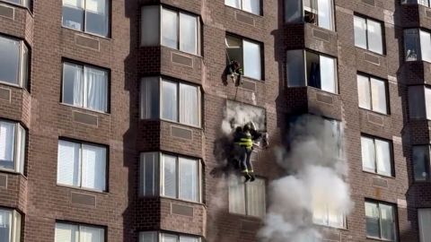 Video shows firefighters rescuing a woman.