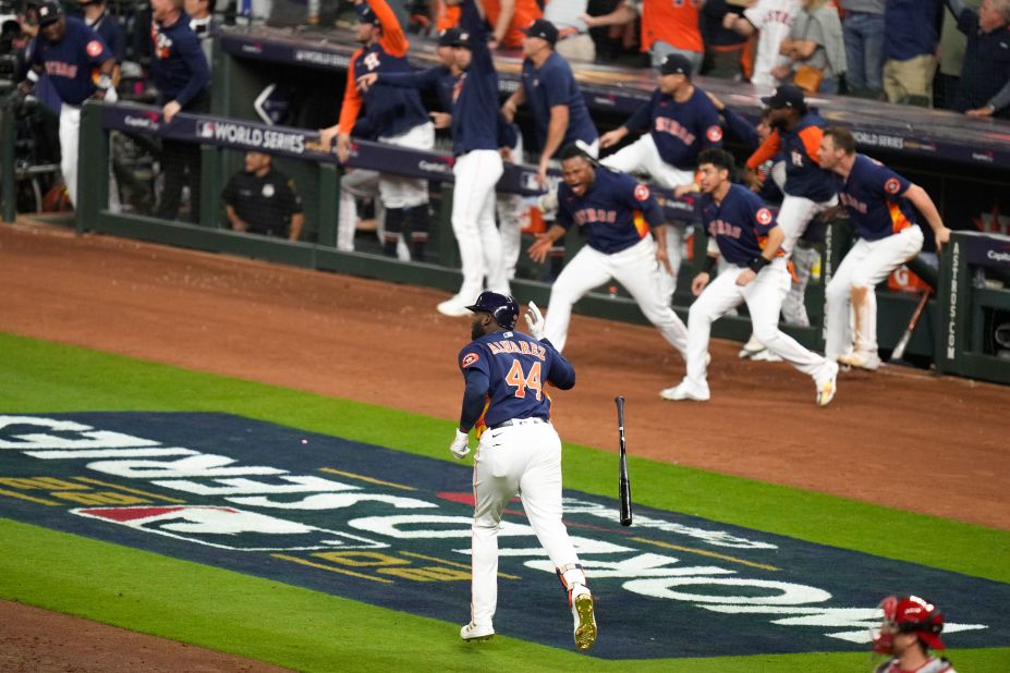 Alvarez's teammates jump out of the dugout as he rounds the bases after hitting his three-run shot in the sixth inning of Saturday's game.