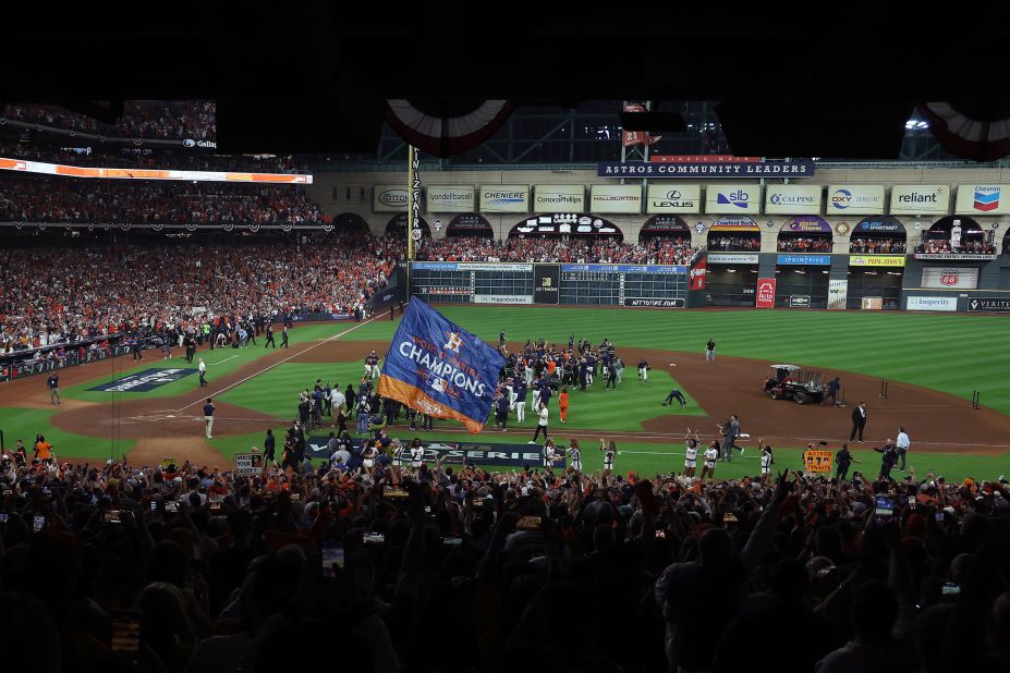 Players and other members of the Astros organization rush onto the field after their victory on Saturday.