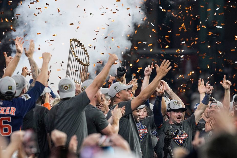 The Astros celebrate with the Commissioner's Trophy.