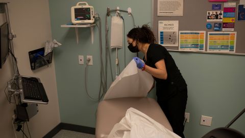Healthcare assistant Samantha Sanchez-Rivera sets up a room for an abortion patient.