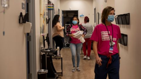 Evans, center, walks down the hall at the clinic.