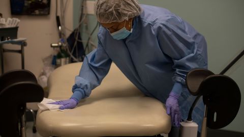 Evans wipes down a patient's room after an abortion procedure.