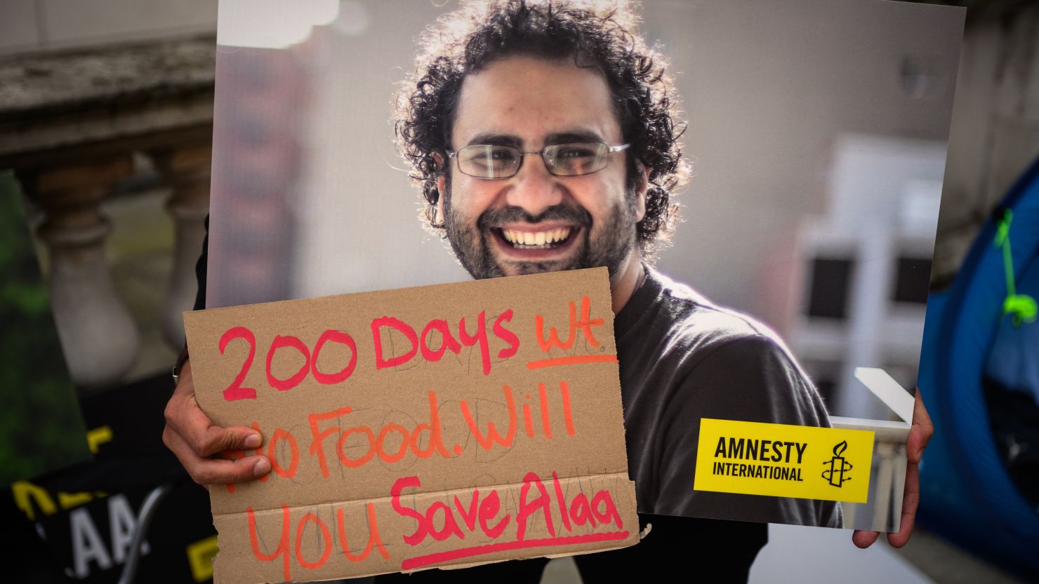 A supporter holds a poster of Alaa Abd El-Fattah during a protest in London in October calling for his release.