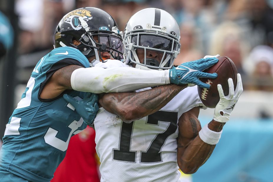 Las Vegas Raiders wide receiver Davante Adams catches a pass for a touchdown while being tightly defended by Jacksonville Jaguars cornerback Tyson Campbell. Despite another excellent afternoon for Adams — finishing with 146 receiving yards and two touchdowns — the Raiders were beaten 27-20 by the Jags. 