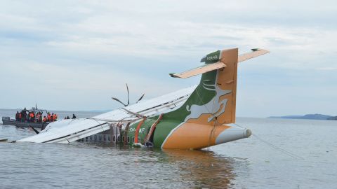 A Precision Air plane is seen partially submerged in Lake Victoria.