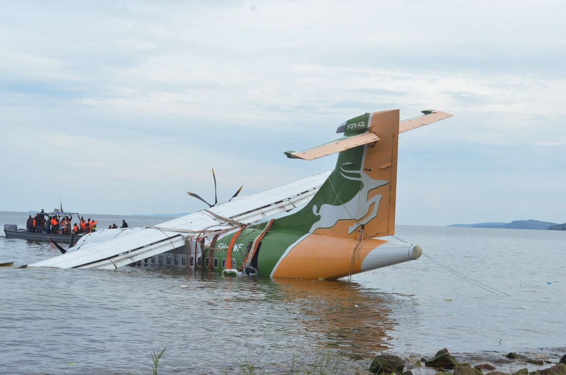 The Precision Air plane is seen partially submerged in Lake Victoria.