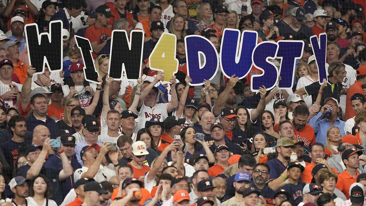 Fans hold up a sign for Houston Astros manager Dusty Baker during Game 6.