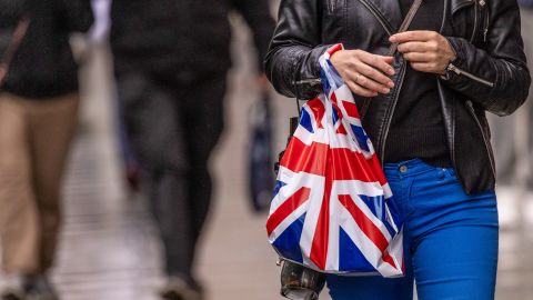 A shopper carries a shopping bag along Oxford Street in central London on Nov. 7, 2022. 