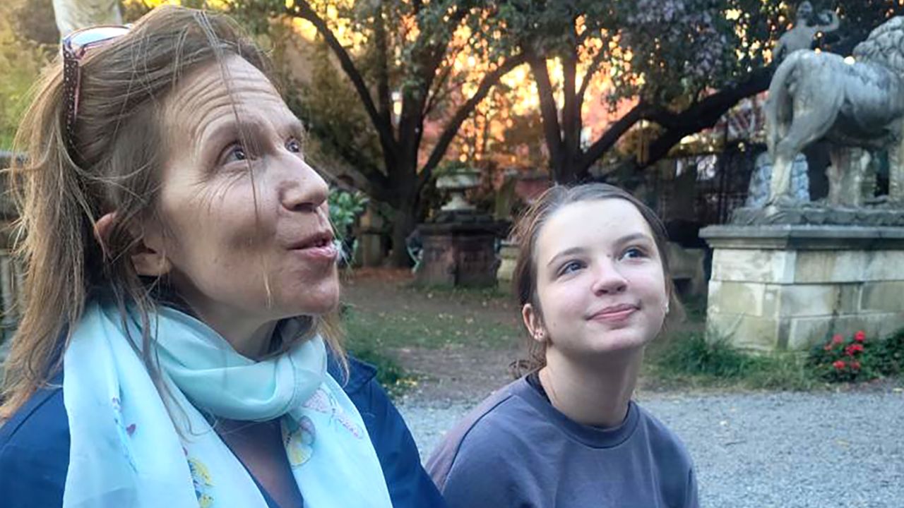 Emmanuelle Chiche and her daughter, Elsa, sit in Elizabeth Street Garden, where Chiche volunteers.