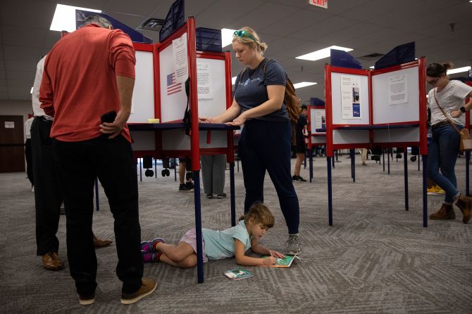 Joy Mahoney votes in Cincinnati as her daughter plays below her on November 4.