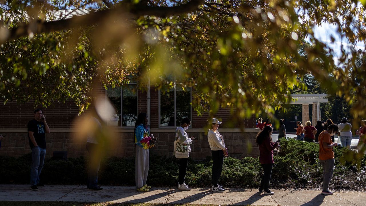 Local residents wait in line to cast their ballots during early voting for the midterm elections at the South Cobb Regional Library, in Mableton Georgia, U.S., November 4, 2022. 
