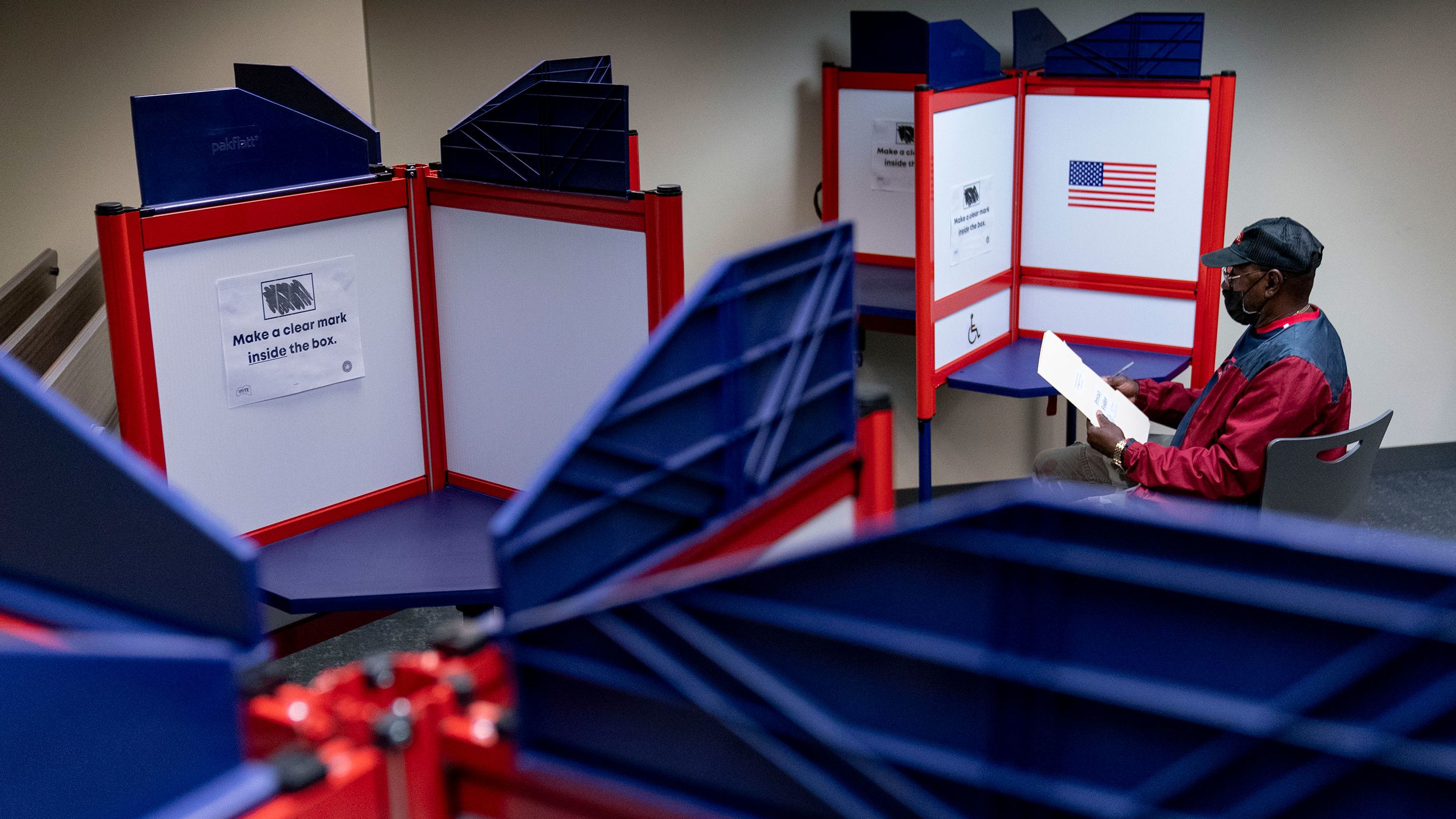 Cornelius Whiting fills out his ballot at an early voting location in Alexandria, Va., Monday, Sept. 26, 2022.