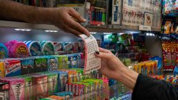 A person receives a lottery ticket for Powerball's 1.6 billion dollar jackpot in New York City, U.S., November 4, 2022. 