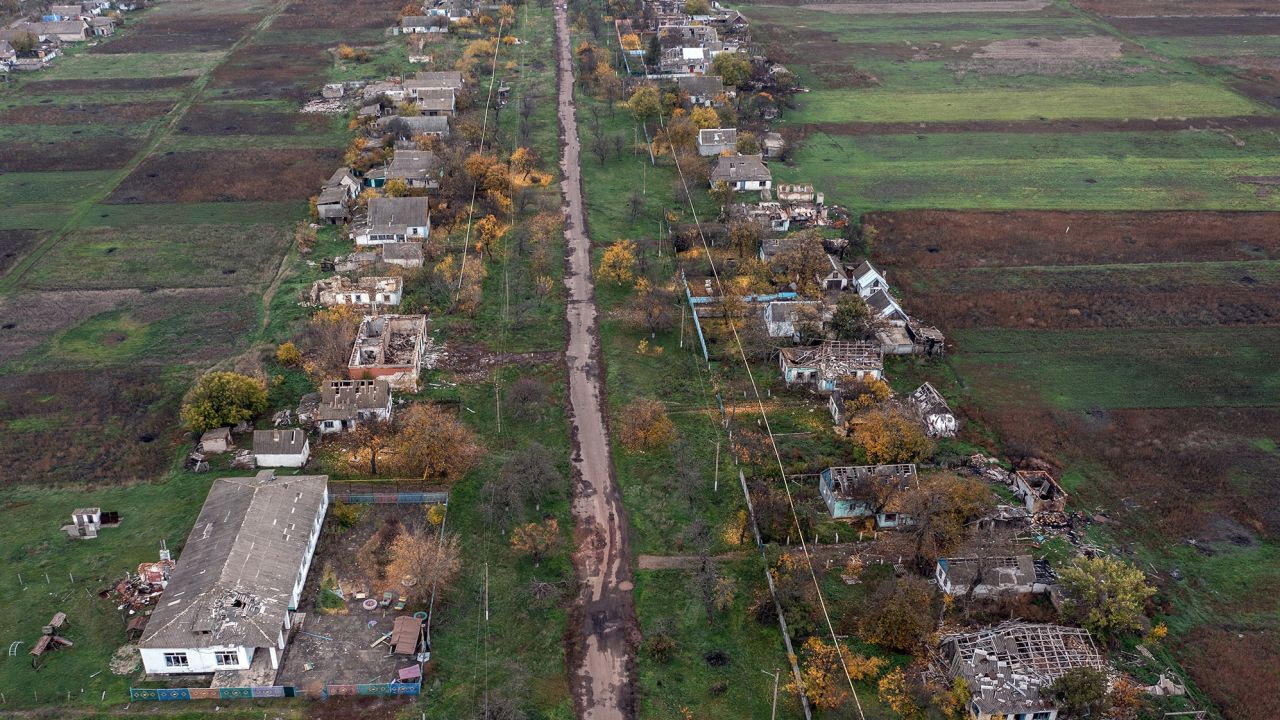 Buildings that were damaged during fighting between Ukrainian and Russian occupying forces line a village road on October 30 in the Kherson region of Ukraine.