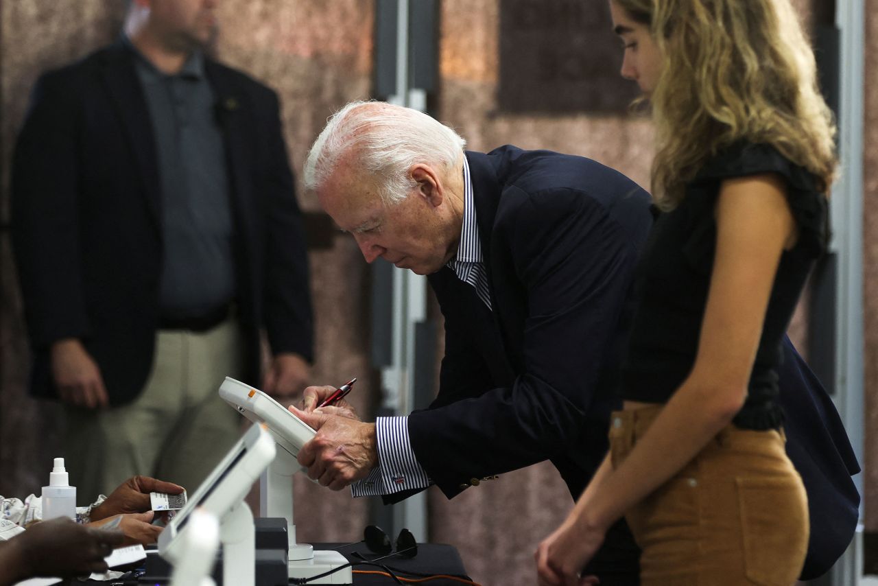 President Joe Biden and his granddaughter Natalie, a first-time voter, prepare to cast their ballots in Wilmington, Delaware, on October 29.