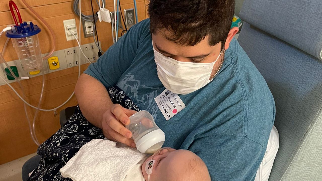 Aaron Chavez feeds his daughter, MJ, three days after her surgery.