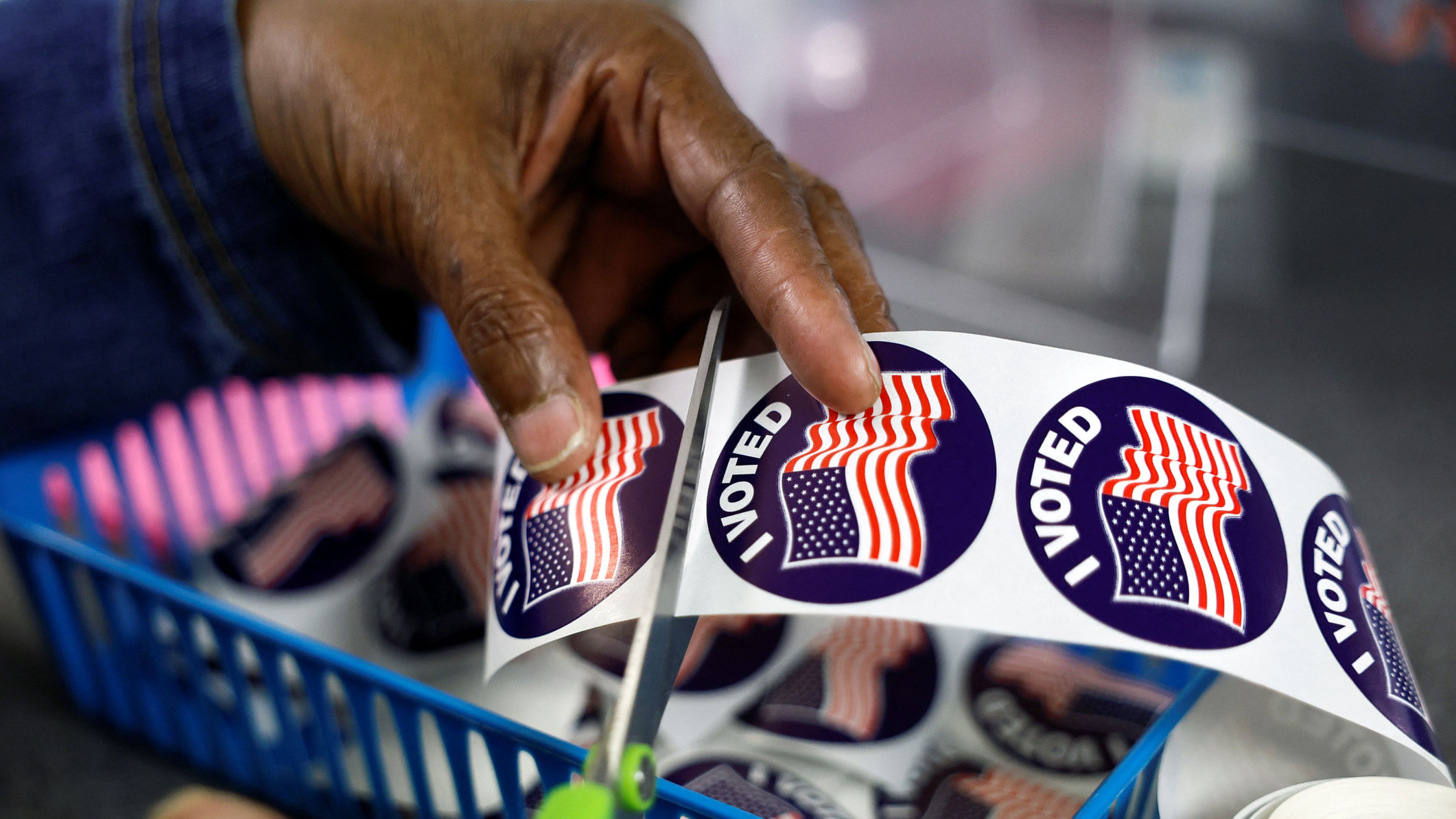 A poll worker prepares "I voted" stickers for voters at the City Clerk's Office ahead of the midterm election in Lansing, Michigan, U.S., November 7, 2022.