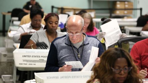 Election workers separate verified ballots from their envelopes at the Orange County Supervisor of Elections headquarters on the eve of the US midterm elections, in Orlando, Florida, on November 7, 2022. (Photo by Gregg Newton / AFP) (Photo by GREGG NEWTON/AFP via Getty Images)