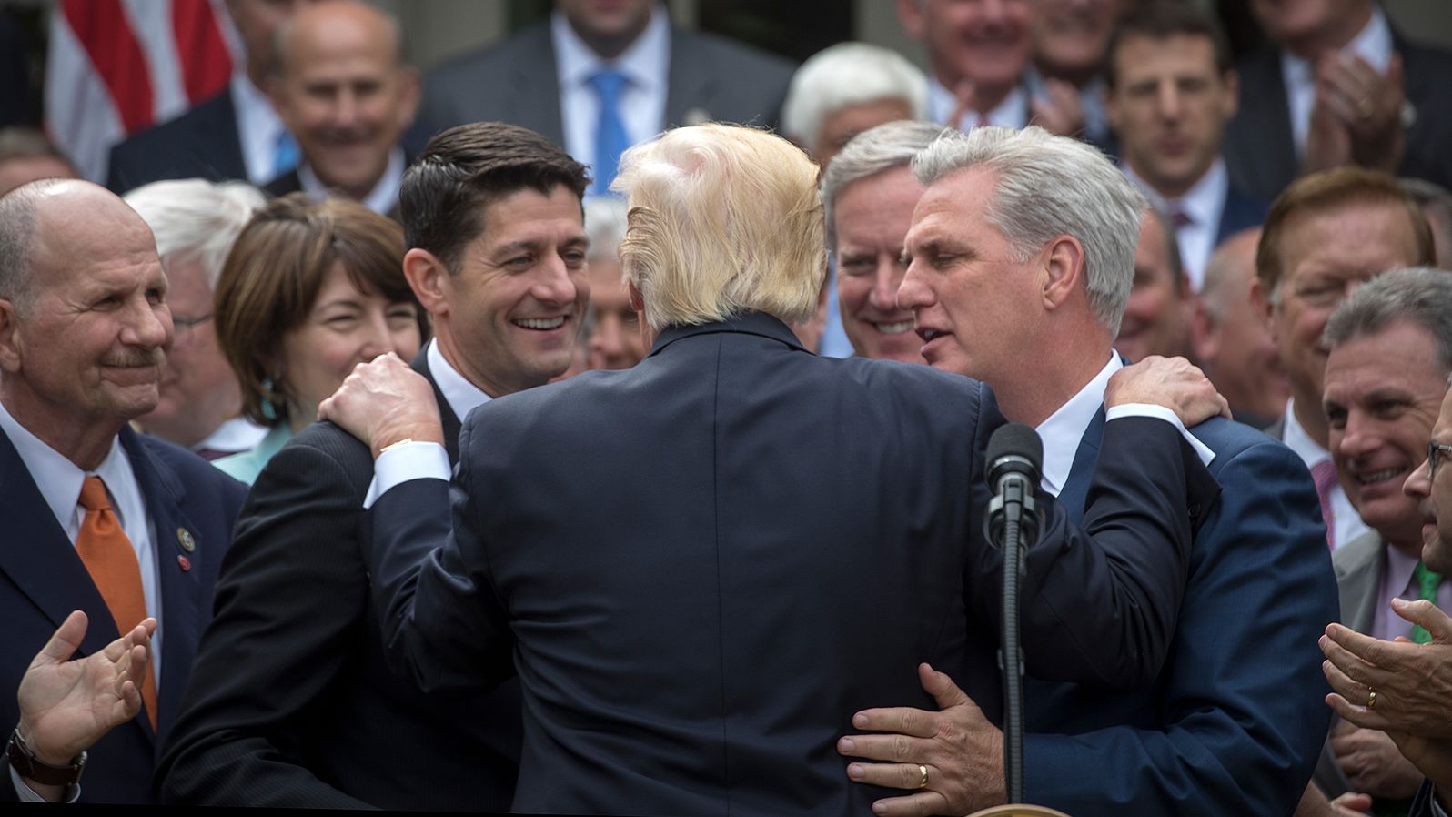 Trump rests his hands on the shoulders of Ryan and McCarthy as Republican leaders celebrated the House's passage of the American Health Care Act in May 2017. The bill failed to make it through the Senate.