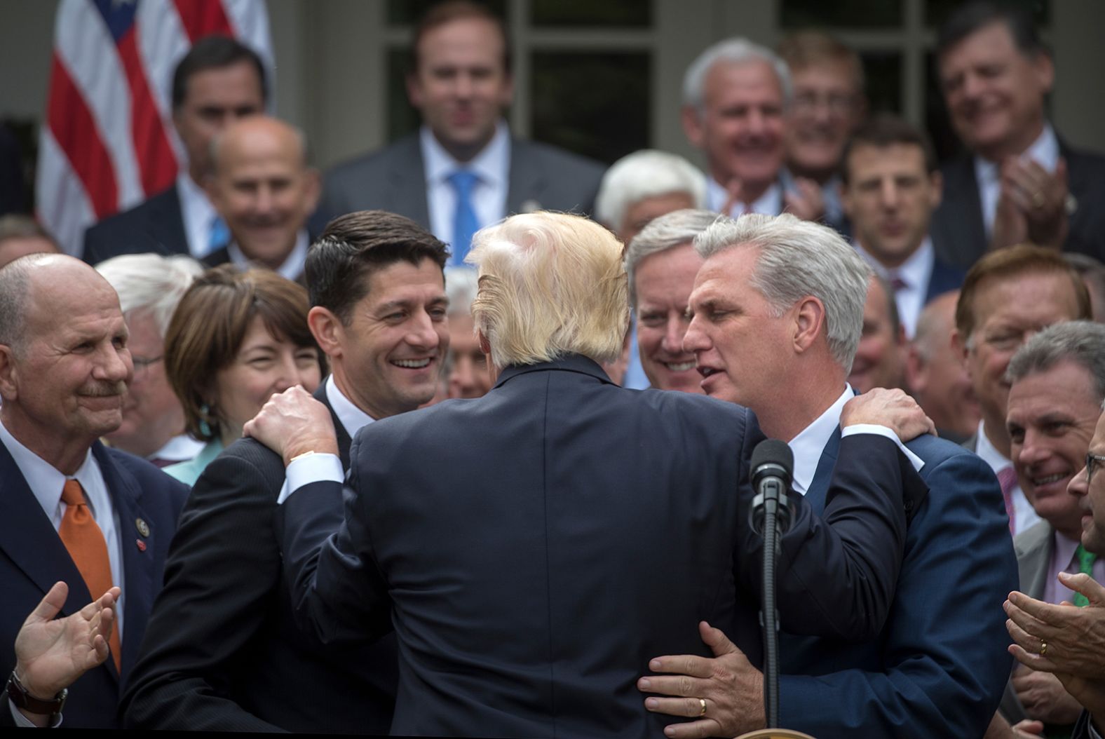 Trump rests his hands on the shoulders of Ryan and McCarthy as Republican leaders celebrated the House's passage of the American Health Care Act in May 2017. The bill failed to make it through the Senate.