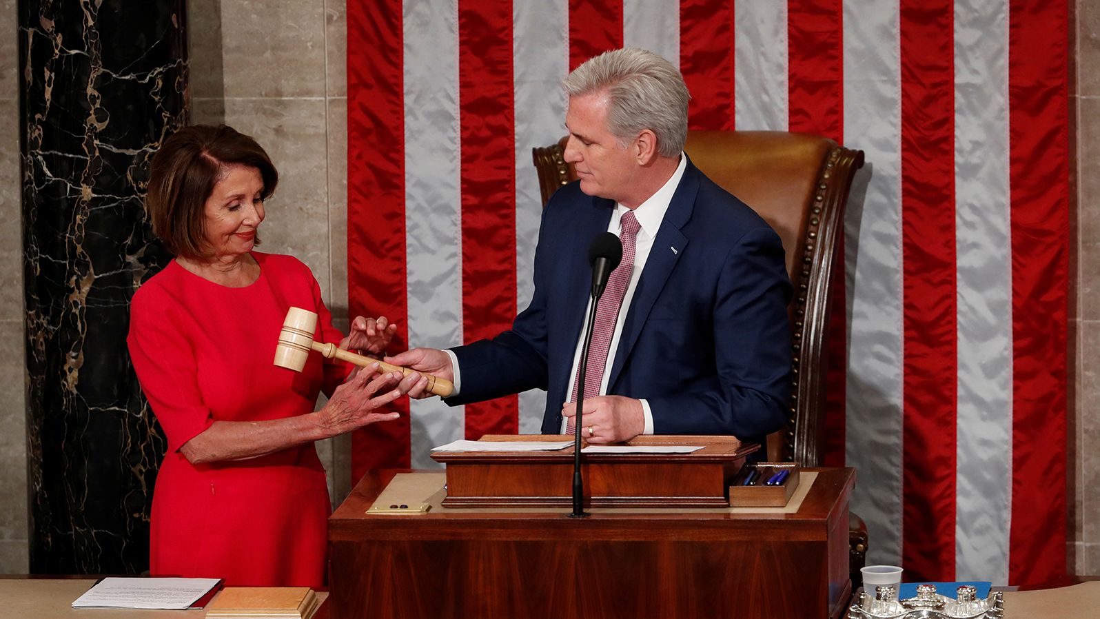Pelosi, the new House speaker, is handed the gavel by McCarthy, the new House minority leader, at the start of the 116th Congress in January 2019.