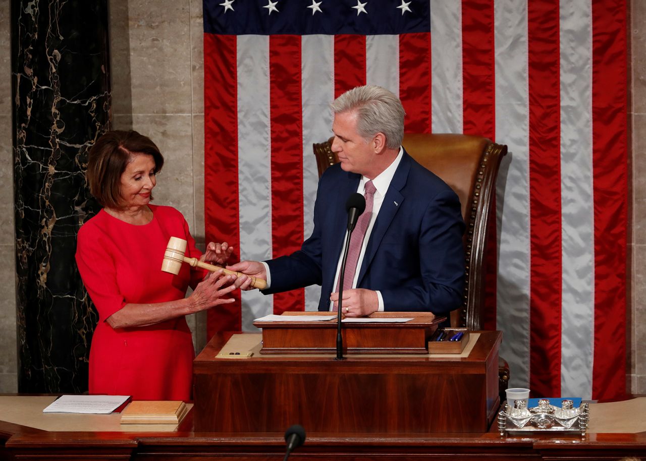 Pelosi, the new House speaker, is handed the gavel by McCarthy, the new House minority leader, at the start of the 116th Congress in January 2019.