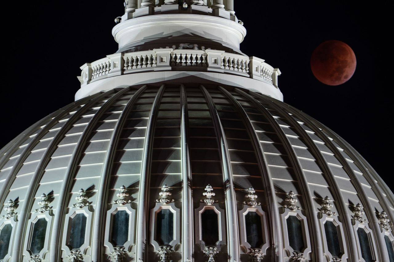 A full lunar eclipse is seen behind the US Capitol early on Tuesday morning.