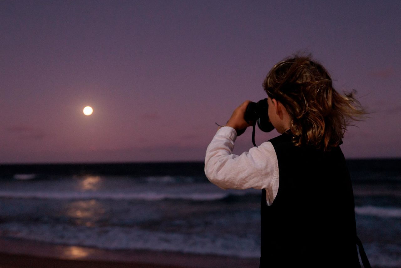 A young boy gazes at the moon on Manly Beach in Sydney as a partial eclipse begins on November 8.
