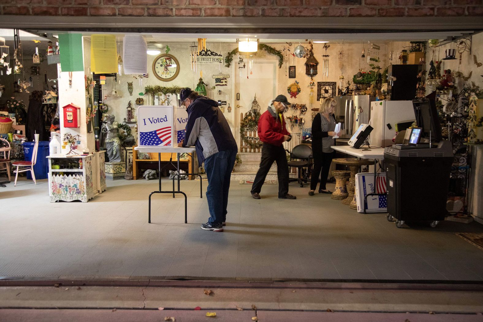 Allegheny County polling coordinator Bob Henrich, left, inspects a polling location in a private resident's garage in Pittsburgh.