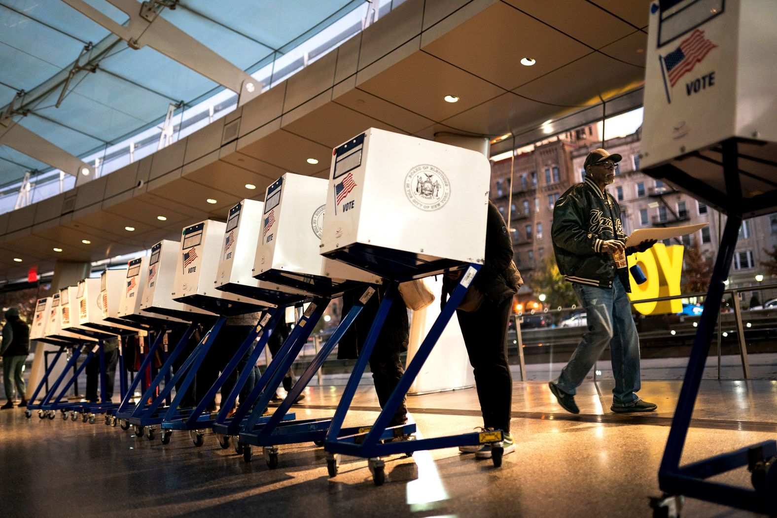 The first voters of the day begin filling out their ballots at the Brooklyn Museum in New York.