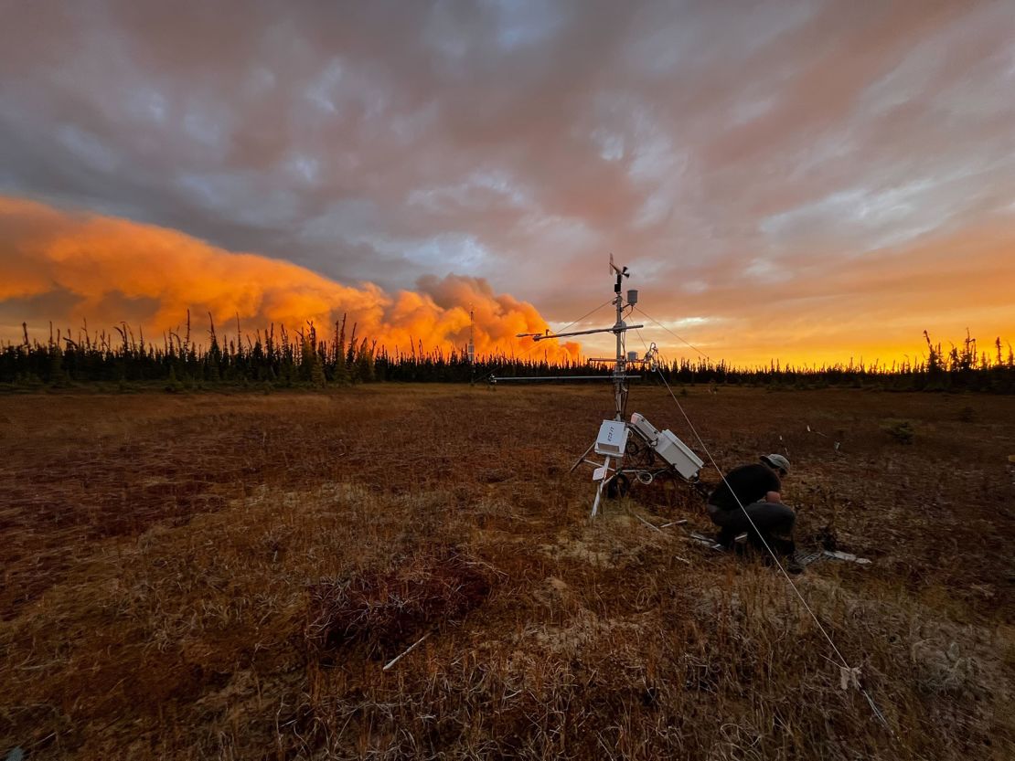 Smoke from a wildfire is visible behind a permafrost monitoring tower at the Scotty Creek Research Station in Canada's Northwest Territories in September. The tower burned down in October from unusual wildfire activity.
