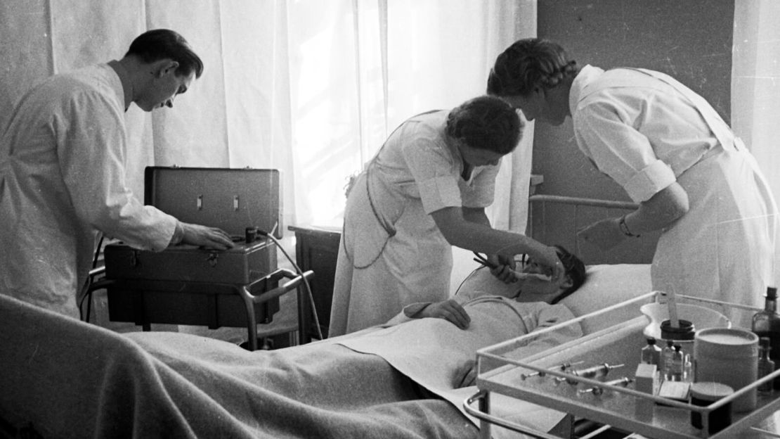 Doctors prepare a patient for electroshock therapy at Augustenborg Psychiatric Hospital in Denmark, 1943.