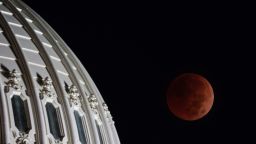 The US Election Day blood moon lunar eclipse is seen behind the US Capitol dome on Tuesday morning, November 8.